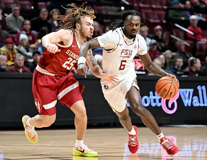Jan 31, 2026; Tallahassee, Florida, USA; Florida State Seminoles guard Robert McCray (6) drives to the net past Stanford Cardinal guard Jeremy Dent-Smith (25) during the first half at Donald L. Tucker Center. Mandatory Credit: Melina Myers-Imagn Images