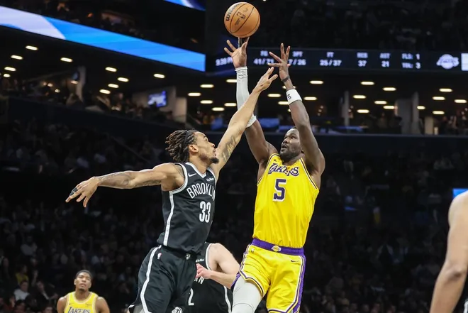 Feb 3, 2026; Brooklyn, New York, USA; Los Angeles Lakers center Deandre Ayton (5) shoots past Brooklyn Nets center Nic Claxton (33) in the fourth quarter at Barclays Center.