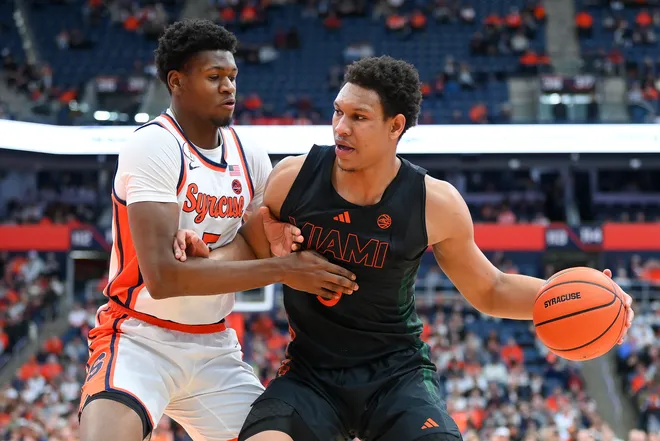 Jan 24, 2026; Syracuse, New York, USA; Miami Hurricanes forward Malik Reneau (right) drives against Syracuse Orange forward Tyler Betsey (left) during the first half at the JMA Wireless Dome. Mandatory Credit: Rich Barnes-Imagn Images