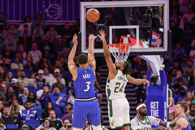 Feb 9, 2026; Orlando, Florida, USA; Orlando Magic guard Desmond Bane (3) shoots against Milwaukee Bucks guard Cam Thomas (24) during the second quarter at Kia Center.