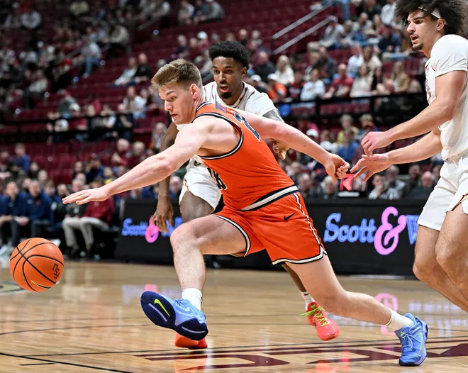 Feb 10, 2026; Tallahassee, Florida, USA; Virginia Cavaliers forward Thijs De Ridder (28) loses the ball as he is defended by Florida State Seminoles forward Chauncey Wiggins (7) and guard Lajae Jones (10) during the first half at Donald L. Tucker Center. Mandatory Credit: Melina Myers-Imagn Images