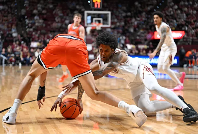 Feb 10, 2026; Tallahassee, Florida, USA; Virginia Cavaliers guard Jacari White (6) fights for a loose ball against Florida State Seminoles guard Martin Somerville (1) during the first half at Donald L. Tucker Center. Mandatory Credit: Melina Myers-Imagn Images