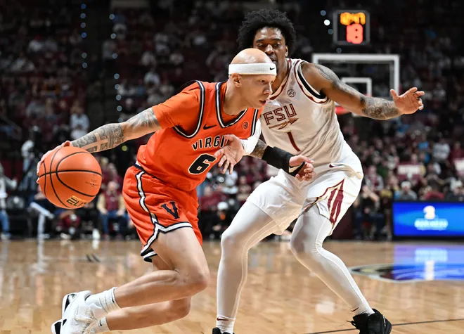 Feb 10, 2026; Tallahassee, Florida, USA; Virginia Cavaliers guard Jacari White (6) dribbles past Florida State Seminoles guard Martin Somerville (1) during the first half at Donald L. Tucker Center. Mandatory Credit: Melina Myers-Imagn Images