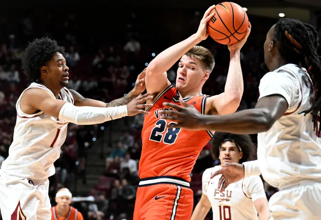 Feb 10, 2026; Tallahassee, Florida, USA; Virginia Cavaliers forward Thijs De Ridder (28) looks to pass the ball as he is defended by Florida State Seminoles guard Martin Somerville (1) during the first half at Donald L. Tucker Center. Mandatory Credit: Melina Myers-Imagn Images