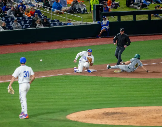 UABÃ•s infielder Alex Cheeseman (8) is safe at third before Florida's infielder Ethan Surowiec (10) gets the ball, Friday, February 13, 2026, at Condron Family Ballpark in Gainesville, Florida. The Gators lost Game 1 to the Blazers 9-7. [Cyndi Chambers/ Gainesville Sun] 2026
