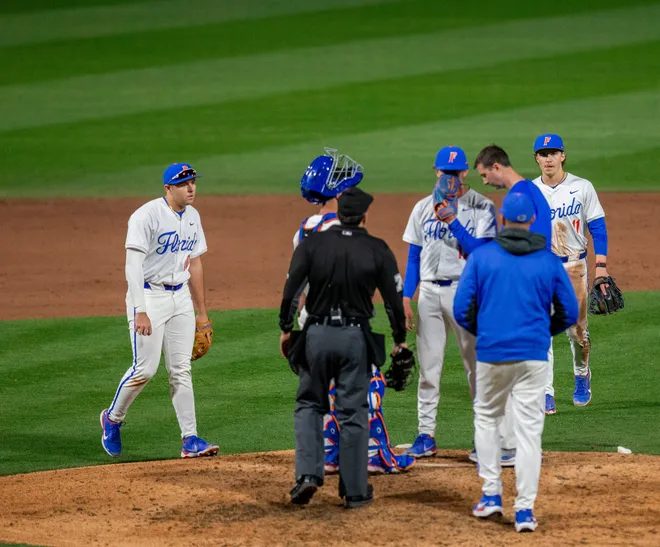 Florida's pitcher Russell Sandefer (17) talks with Athletic Trainer Jarrett Schweim, Friday, February 13, 2026, at Condron Family Ballpark in Gainesville, Florida. The Gators lost Game 1 to the Blazers 9-7. [Cyndi Chambers/ Gainesville Sun] 2026