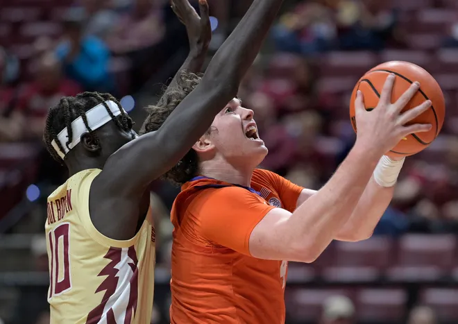 Feb 15, 2025; Tallahassee, Florida, USA; Clemson Tigers forward Ian Schieffelin (4) shoots the ball past Florida State Seminoles forward Taylor Bol Bowen (10) during the first half at Donald L. Tucker Center. Mandatory Credit: Melina Myers-Imagn Images