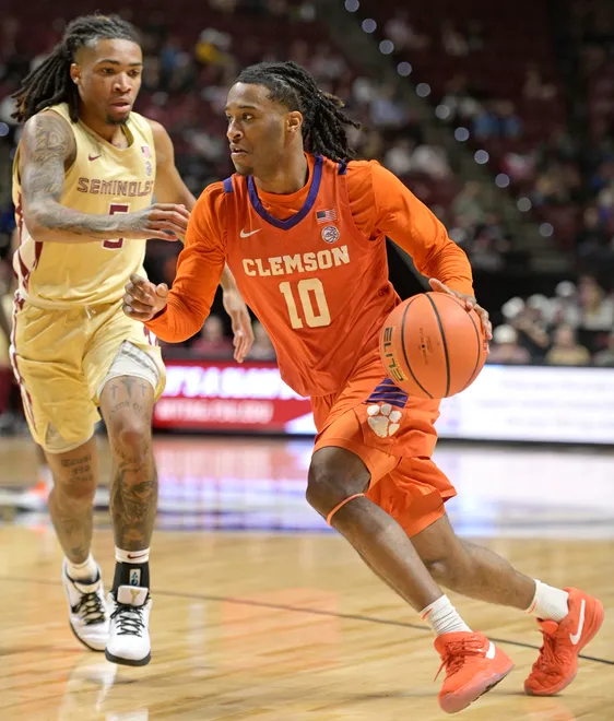 Feb 15, 2025; Tallahassee, Florida, USA; Clemson Tigers guard Del Jones (10) dribbles the ball against Florida State Seminoles guard DaQuan Davis (5) during the second half of the game at Donald L. Tucker Center. Mandatory Credit: Melina Myers-Imagn Images