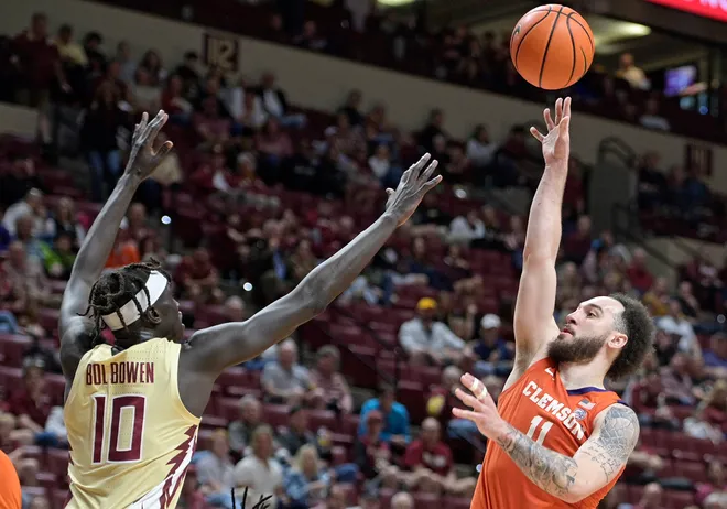 Feb 15, 2025; Tallahassee, Florida, USA; Clemson Tigers guard Jaeden Zackery (11) shoots past Florida State Seminoles forward Taylor Bol Bowen (10) during the second half at Donald L. Tucker Center. Mandatory Credit: Melina Myers-Imagn Images