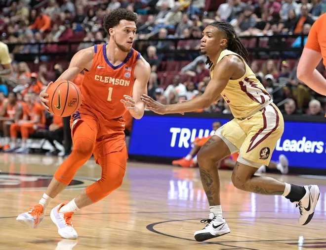Feb 15, 2025; Tallahassee, Florida, USA; Clemson Tigers guard Chase Hunter (1) dribbles the ball as Florida State Seminoles guard DaQuan Davis (5) defends during the first half at Donald L. Tucker Center. Mandatory Credit: Melina Myers-Imagn Images