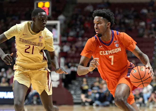 Feb 15, 2025; Tallahassee, Florida, USA; Clemson Tigers forward Chauncey Wiggins (7) drives around Florida State Seminoles forward Alier Maluk (21) during the second half at Donald L. Tucker Center. Mandatory Credit: Melina Myers-Imagn Images