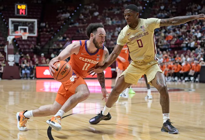 Feb 15, 2025; Tallahassee, Florida, USA; Clemson Tigers guard Jaeden Zakery (11) dribbles the ball around Florida State Seminoles guard Chandler Jackson (0) during the first half at Donald L. Tucker Center. Mandatory Credit: Melina Myers-Imagn Images