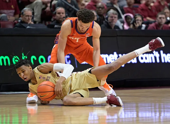 Feb 15, 2025; Tallahassee, Florida, USA; Clemson Tigers guard Chase Hunter (1) and Florida State Seminoles guard Justin Thomas (25) battle for a loose ball during the first half at Donald L. Tucker Center. Mandatory Credit: Melina Myers-Imagn Images