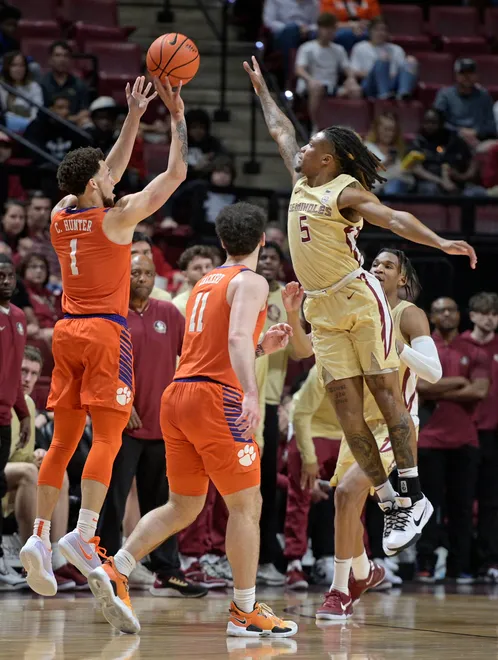 Feb 15, 2025; Tallahassee, Florida, USA; Clemson Tigers guard Chase Hunter (1) shoots the ball as Florida State Seminoles guard DaQuan Davis (5) defends during the first half at Donald L. Tucker Center. Mandatory Credit: Melina Myers-Imagn Images
