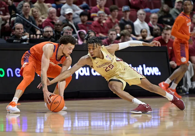 Feb 15, 2025; Tallahassee, Florida, USA; Clemson Tigers guard Chase Hunter (1) reaches for a loose ball as Florida State Seminoles guard Justin Thomas (25) dives for the ball during the first half at Donald L. Tucker Center. Mandatory Credit: Melina Myers-Imagn Images