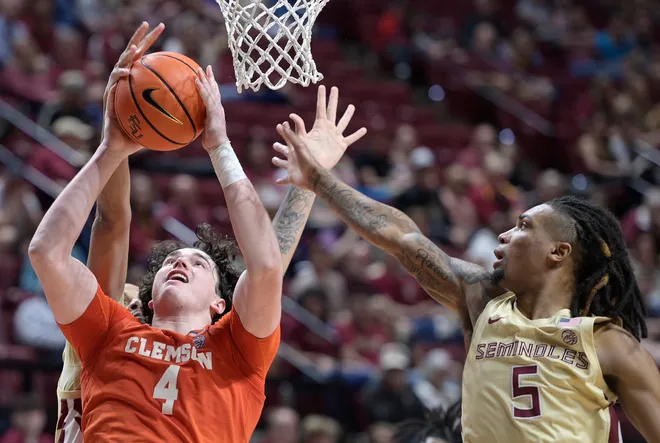 Feb 15, 2025; Tallahassee, Florida, USA; Clemson Tigers forward Ian Schieffelin (4) recovers a rebound past Florida State Seminoles guard DaQuan Davis (5) during the second half at Donald L. Tucker Center. Mandatory Credit: Melina Myers-Imagn Images