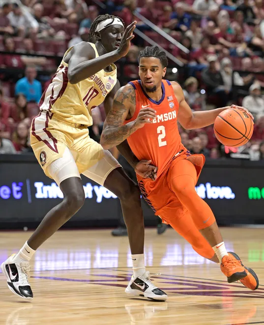 Feb 15, 2025; Tallahassee, Florida, USA; Clemson Tigers guard Dillon Hunter (2) drives to the basket as Florida State Seminoles forward Taylor Bol Bowen (10) defends during the second half at Donald L. Tucker Center. Mandatory Credit: Melina Myers-Imagn Images