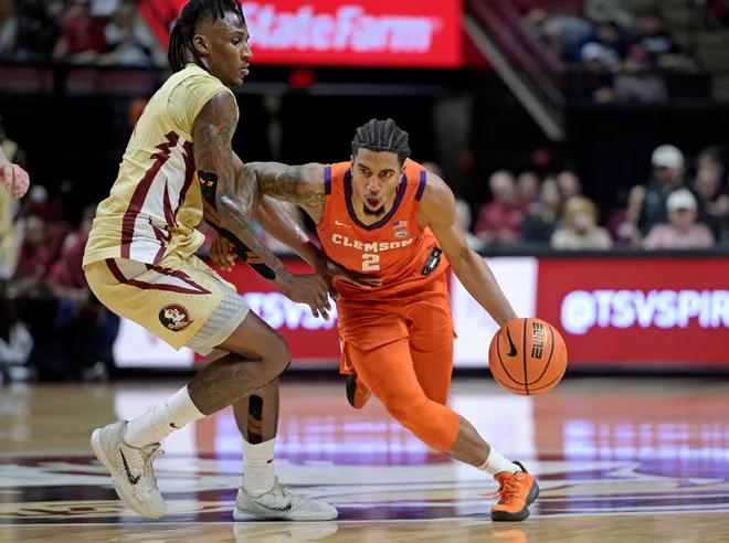 Feb 15, 2025; Tallahassee, Florida, USA; Clemson Tigers guard Dillon Hunter (2) drives up the court against Florida State Seminoles forward Jamir Watkins (1) during the second half at Donald L. Tucker Center. Mandatory Credit: Melina Myers-Imagn Images
