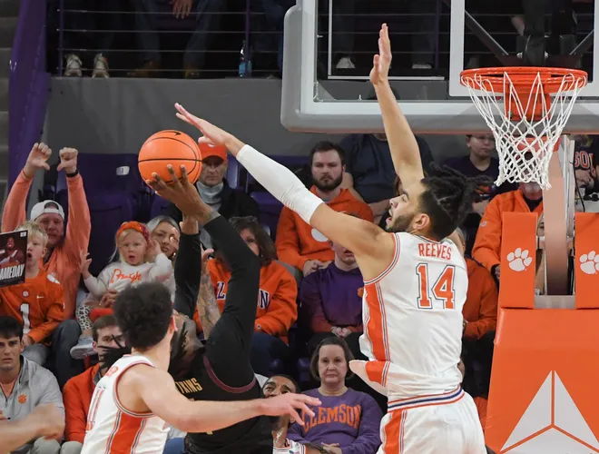 Jan 11, 2025; Clemson, South Carolina, USA; Clemson Tigers center Christian Reeves (14) blocks a shot by Florida State Seminoles guard Jamir Watkins (1) during the first half at Littlejohn Coliseum. Mandatory Credit: Ken Ruinard/USA TODAY Network via Imagn Images
