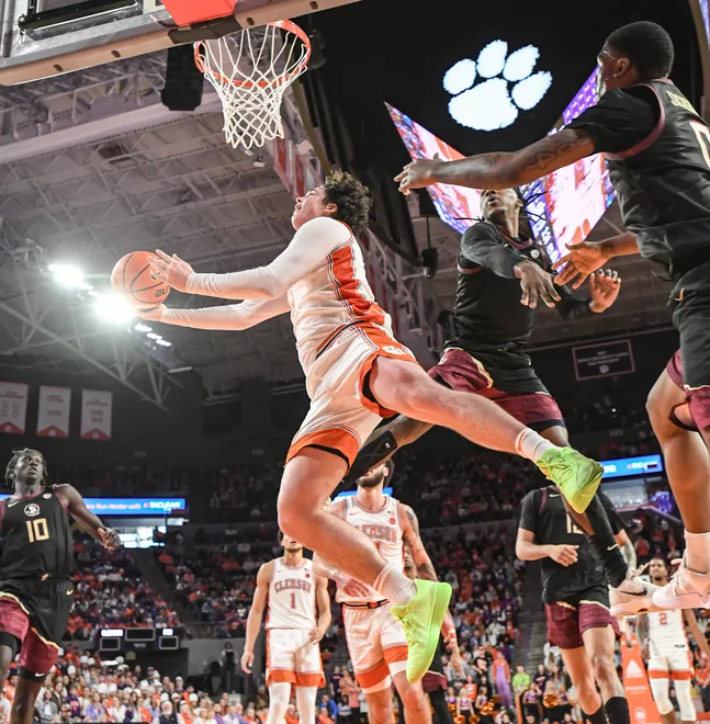 Jan 11, 2025; Clemson, South Carolina, USA; Clemson Tigers forward Ian Schieffelin (4) shoots the ball against Florida State Seminoles guard Chandler Jackson (0) during the second half at Littlejohn Coliseum. Mandatory Credit: Ken Ruinard/USA TODAY Network via Imagn Images