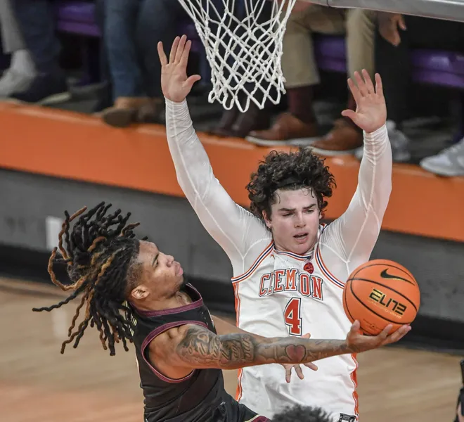 Jan 11, 2025; Clemson, South Carolina, USA; Florida State Seminoles guard Daquan Davis (5) shoots the ball against Clemson Tigers forward Ian Schieffelin (4) during the first half at Littlejohn Coliseum. Mandatory Credit: Ken Ruinard/USA TODAY Network via Imagn Images