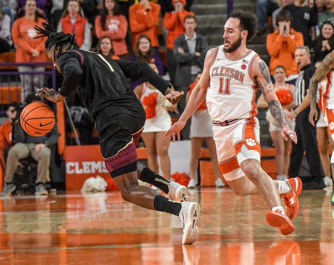 Jan 11, 2025; Clemson, South Carolina, USA; Florida State Seminoles guard Jamir Watkins (1) dribbles the ball against Clemson Tigers guard Jaeden Zachery (11) during the second half at Littlejohn Coliseum. Mandatory Credit: Ken Ruinard/USA TODAY Network via Imagn Images