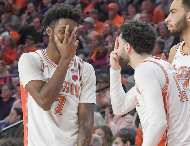 Jan 11, 2025; Clemson, South Carolina, USA; Clemson Tigers forward Chauncey Wiggins (7) and guard Andrew Latiff (13) react after aa three-point basket by guard Jaeden Zachery (not pictured) against the Florida State Seminoles during the second half at Littlejohn Coliseum. Mandatory Credit: Ken Ruinard/USA TODAY Network via Imagn Images