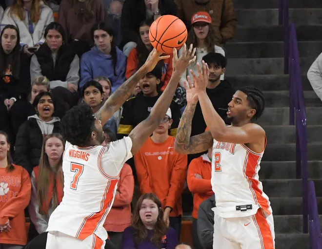 Jan 11, 2025; Clemson, South Carolina, USA; Clemson Tigers forward Chauncey Wiggins (7) and Clemson Tigers guard Dillon Hunter (2) reach for a rebound during the second half at Littlejohn Coliseum. Mandatory Credit: Ken Ruinard/USA TODAY Network via Imagn Images