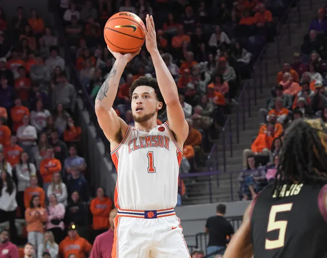 Jan 11, 2025; Clemson, South Carolina, USA; Clemson Tigers guard Chase Hunter (1) shoots the ball against Florida State Seminoles guard Daquan Davis (5) during the second half at Littlejohn Coliseum. Mandatory Credit: Ken Ruinard/USA TODAY Network via Imagn Images
