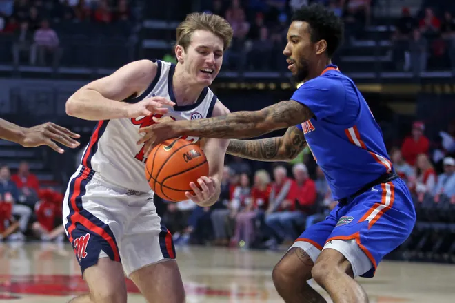 Feb 21, 2026; Oxford, Mississippi, USA; Mississippi Rebels guard Travis Perry (11) drives to the basket as Florida Gators guard Boogie Fland (0) defends during the first half at The Sandy and John Black Pavilion at Ole Miss. Mandatory Credit: Petre Thomas-Imagn Images