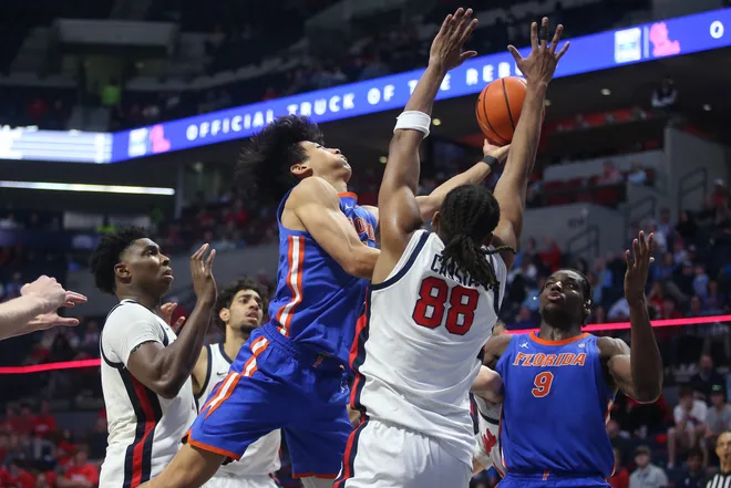 Feb 21, 2026; Oxford, Mississippi, USA; Florida Gators guard Xaivian Lee (1) drives to the basket as Mississippi Rebels forward Augusto Cassia (88) defends during the second half at The Sandy and John Black Pavilion at Ole Miss. Mandatory Credit: Petre Thomas-Imagn Images