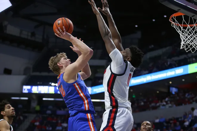 Feb 21, 2026; Oxford, Mississippi, USA; Florida Gators forward Thomas Haugh (10) shoots as Mississippi Rebels forward Malik Dia (0) defends during the second half at The Sandy and John Black Pavilion at Ole Miss. Mandatory Credit: Petre Thomas-Imagn Images