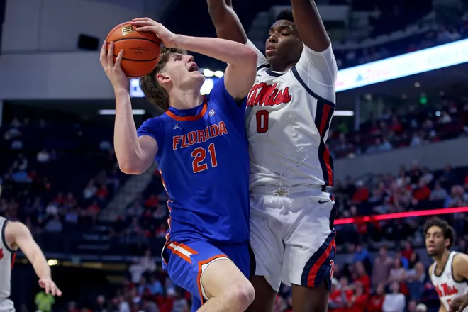 Feb 21, 2026; Oxford, Mississippi, USA; Florida Gators forward/center Alex Condon (21) drives to the basket as Mississippi Rebels forward Malik Dia (0) defends during the second half at The Sandy and John Black Pavilion at Ole Miss. Mandatory Credit: Petre Thomas-Imagn Images