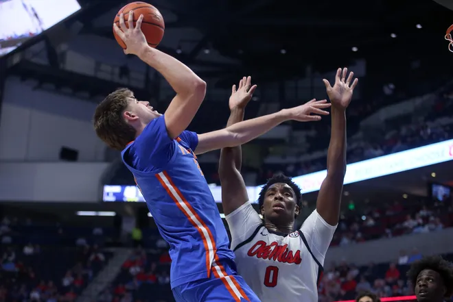 Feb 21, 2026; Oxford, Mississippi, USA; Florida Gators forward/center Alex Condon (21) shoots as Mississippi Rebels forward Malik Dia (0) defends during the second half at The Sandy and John Black Pavilion at Ole Miss. Mandatory Credit: Petre Thomas-Imagn Images