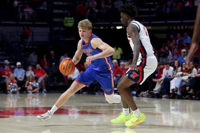 Feb 21, 2026; Oxford, Mississippi, USA; Florida Gators forward Thomas Haugh (10) dribbles as Mississippi Rebels forward Corey Chest (1) defends during the second half at The Sandy and John Black Pavilion at Ole Miss. Mandatory Credit: Petre Thomas-Imagn Images