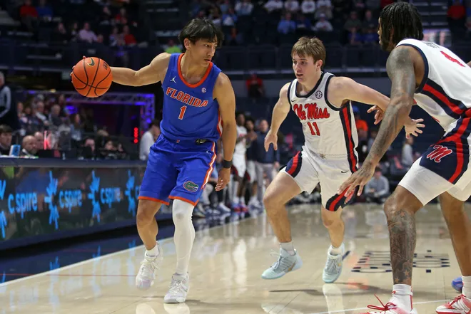 Feb 21, 2026; Oxford, Mississippi, USA; Florida Gators guard Xaivian Lee (1) dribbles as Mississippi Rebels guard Travis Perry (11) defends during the second half at The Sandy and John Black Pavilion at Ole Miss. Mandatory Credit: Petre Thomas-Imagn Images