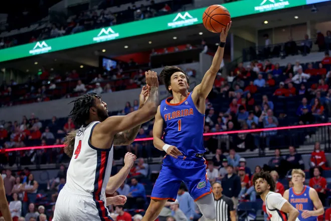 Feb 21, 2026; Oxford, Mississippi, USA; Florida Gators guard Xaivian Lee (1) shoots as Mississippi Rebels forward James Scott (4) defends during the second half at The Sandy and John Black Pavilion at Ole Miss. Mandatory Credit: Petre Thomas-Imagn Images