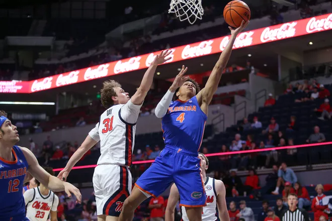 Feb 21, 2026; Oxford, Mississippi, USA; Florida Gators guard Alex Lloyd (4) shoots as Mississippi Rebels guard Zach Day (31) defends during the second half at The Sandy and John Black Pavilion at Ole Miss. Mandatory Credit: Petre Thomas-Imagn Images