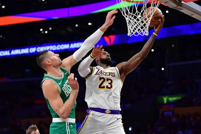 Feb 22, 2026; Los Angeles, California, USA; Los Angeles Lakers forward LeBron James (23) shoots against Boston Celtics center Nikola Vucevic (4) during the second half at Crypto.com Arena.