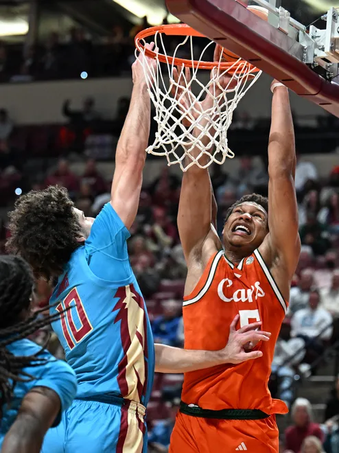 Feb 24, 2026; Tallahassee, Florida, USA; Miami Hurricanes forward Malik Reneau (5) goes up for a dunk against Florida State Seminoles guard Laje Jones (10) during the first half at Donald L. Tucker Center. Mandatory Credit: Melina Myers-Imagn Images
