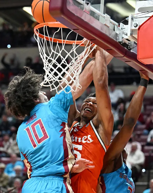 Feb 24, 2026; Tallahassee, Florida, USA; Miami Hurricanes forward Malik Reneau (5) goes up for a dunk against Florida State Seminoles guard Laje Jones (10) during the first half at Donald L. Tucker Center. Mandatory Credit: Melina Myers-Imagn Images