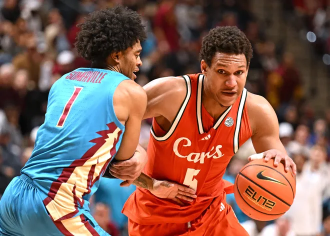 Feb 24, 2026; Tallahassee, Florida, USA; Miami Hurricanes forward Treyvon Maddox (5) dribbles the ball past Florida State Seminoles guard Martin Somerville (1) during the second half at Donald L. Tucker Center. Mandatory Credit: Melina Myers-Imagn Images