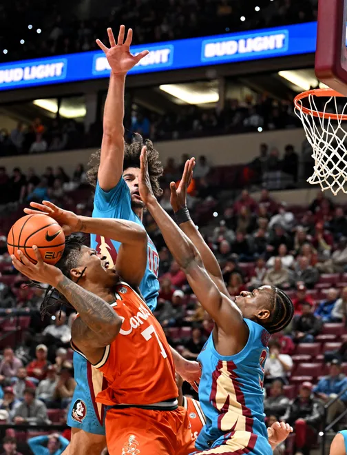 Feb 24, 2026; Tallahassee, Florida, USA; Miami Hurricanes forward Shelton Henderson (7) shoots as Florida State Seminoles forward Thomas Bassong (3) and guard Lajae Jones (10) defend during the first half at Donald L. Tucker Center. Mandatory Credit: Melina Myers-Imagn Images