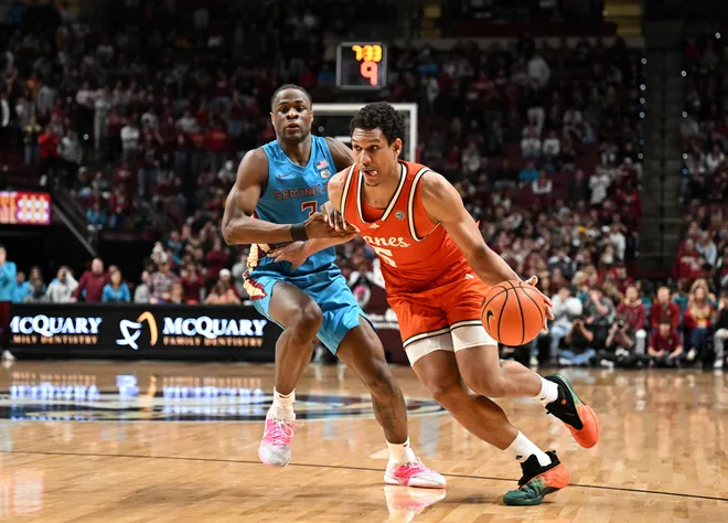 Feb 24, 2026; Tallahassee, Florida, USA; Miami Hurricanes forward Treyvon Maddox (5) drives the ball up the court past Florida State Seminoles forward Thomas Bassong (3) during the second half at Donald L. Tucker Center. Mandatory Credit: Melina Myers-Imagn Images