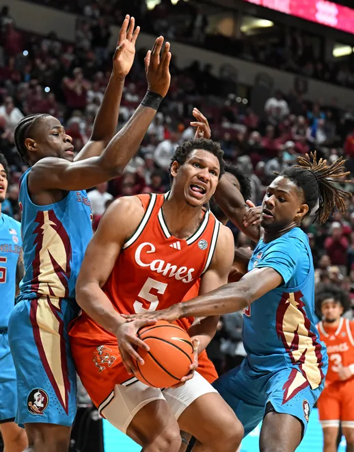 Feb 24, 2026; Tallahassee, Florida, USA; Miami Hurricanes forward Treyvon Maddox (5) battles for a rebound against Florida State Seminoles forward Thomas Bassong (3) and forward AJ Swinton (19) during the second half at Donald L. Tucker Center. Mandatory Credit: Melina Myers-Imagn Images