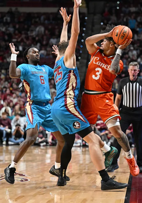 Feb 24, 2026; Tallahassee, Florida, USA; Miami Hurricanes guard Tre Donaldson (3) looks to pass as he falls out of bounds as he is defended by Florida State Seminoles guard Robert McCray (6) and forward Alex Steen (25) during the second half at Donald L. Tucker Center. Mandatory Credit: Melina Myers-Imagn Images