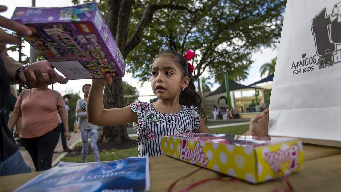 Ashley Lopez, 6, plays with her new toys as the Amigos for Kids Toy Drive Caravan made it's final stop at Jose Marti Park in Little Havana on Sunday, December 16, 2018. Amigos for Kids was among 208 nonprofit organizations selected nationwide for an OpenAI Ready Award, the nonprofit announced Tuesday, Feb. 17, 2026.