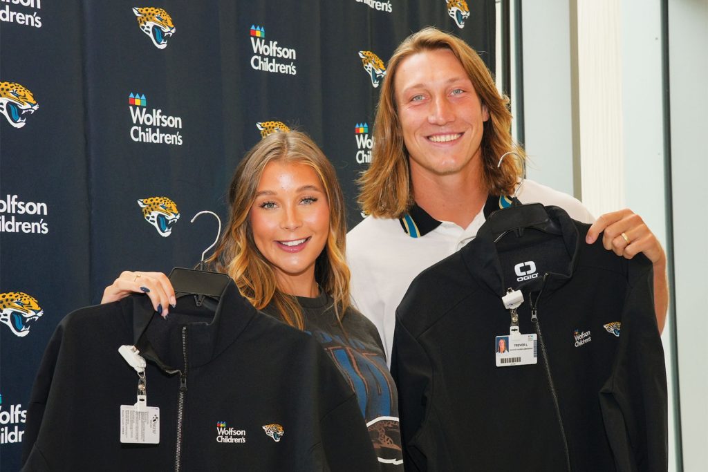 Marking the start of their ambassador roles, Trevor and Marissa Lawrence pose with their official jackets and badges at a September 2024 signing ceremony at Wolfson Children’s Hospital