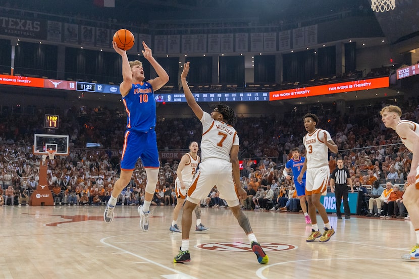 Florida forward Thomas Haugh (10) shoots over Texas guard Simeon Wilcher (7) during the...