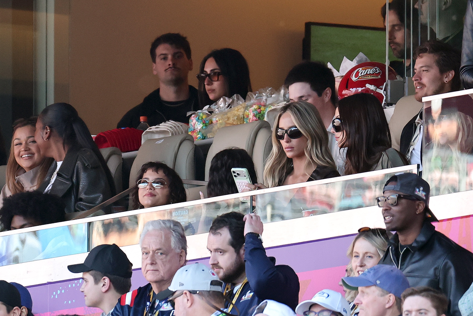 photo of people in a box in the stands at a football game